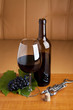 One glass and a bottle of red wine served at table
