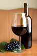 One glass and a bottle of red wine served at table