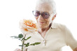 Happy senior woman with rose flower over white background