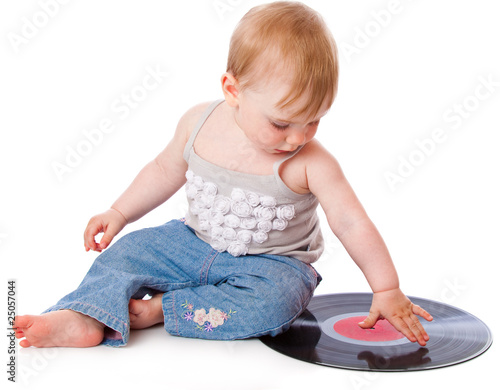 Photo: The small child with a black gramophone record The small child with a black gramophone record