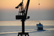 Industrial crane and ship departing Industrial crane and ship departing
