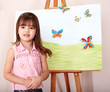 Child with easel in  preschool.
