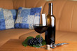 One glass and a bottle of red wine served at table