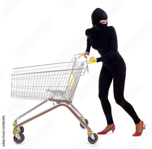 Photo: thief in black clothes and balaclava with shopping cart thief in black clothes and balaclava with shopping cart