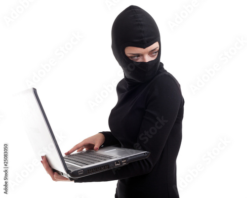 Photo: female criminal in balaclava with the laptop female criminal in balaclava with the laptop