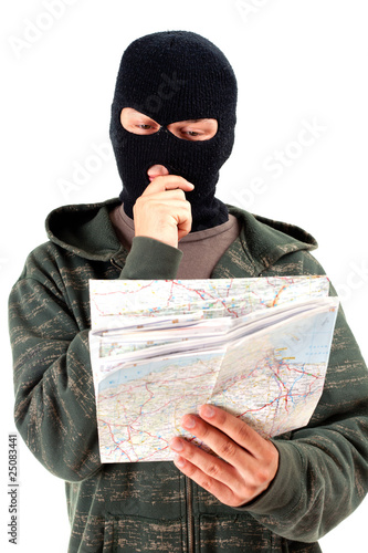 Photo: thief in black balaclava with map thief in black balaclava with map