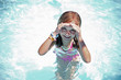 Girl enjoys summer day at the swimming pool.