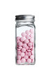 Pink Pills, stored in screw top glass container on white Pink Pills, stored in screw top glass container on white