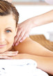 Close-up of a beautiful woman receiving a back massage looking a Close-up of a beautiful woman receiving a back massage looking a