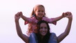 Mother with her daughter on her shoulder