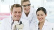 portrait of Chemists looking through a Microscope