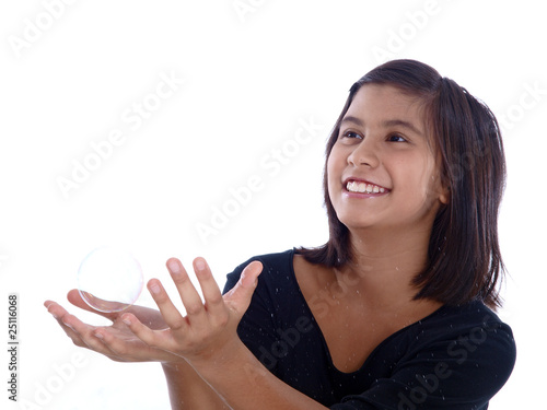 Photo: smiling girl catching a soap bubble smiling girl catching a soap bubble
