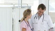 handsome doctor speaking with a nurse in a day hospital