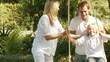 Happy Parents help their son on a swing