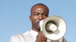 African businessman giving instructions through a megaphone