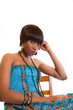 Unhappy girl in blue sitting on chair