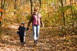 Photo: Mother and son taking a walk in autumn forest Mother and son taking a walk in autumn forest