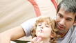 father and son doing soap bubbles during camping