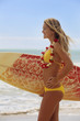 teenage girl in yellow bikini with surfboard at a hawaii beach