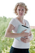 Woman holding a touchscreen tablet