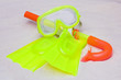 A child's snorkel, mask and flippers laying on the sand