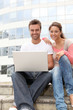 Couple of friends in college campus with laptop computer Couple of friends in college campus with laptop computer