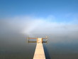 Leerer Steg und Nebel am See
