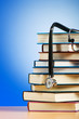Books and stethoscope against the gradient background