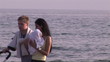 young couple with baby along the sea