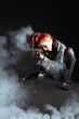 beautiful sexy girl holding gun . smoke background