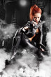 beautiful sexy girl holding gun . smoke background