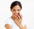 Beautiful young woman eating an apple isolated over white