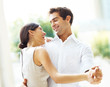 Lovely young couple dancing together and smiling Lovely young couple dancing together and smiling
