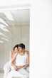 Affectionate mature couple sitting on bed and looking at copyspa Affectionate mature couple sitting on bed and looking at copyspa