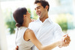 Romantic young couple dancing and laughing together