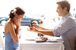 Happy young man gifting a ring to a beautiful woman