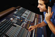 Sound recording studio  - Young guy working with synthesizer
