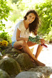 Happy female gardener with gardening tools smiling