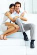 Cute young love couple sitting together on steps Cute young love couple sitting together on steps