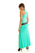 Back view of smiling young woman in long green dress