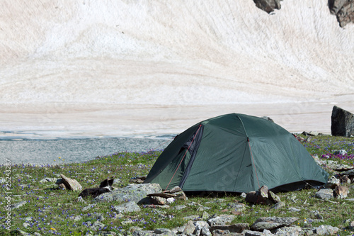 Photo: Gray camping tent in mountains. Gray camping tent in mountains.