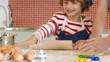 close-up of a boy baking with his mother