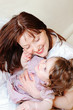 Beautiful mother hugs her cute baby daughter Beautiful mother hugs her cute baby daughter
