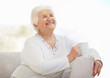 Woman relaxing on sofa while holding a cup of tea or coffee