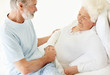 Caring mature man comforting a sick senior woman