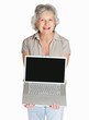 Happy mature woman displaying laptop isolated against white