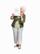 Senior woman holding sheet of sad smiley isolated against white