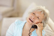 Closeup of a senior woman talking on phone while looking up