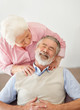Mature man receiving shoulder massage from a senior woman