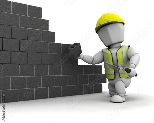 man laying blocks building a wall